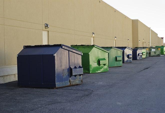 big yellow dumpsters on a construction lot in Bagdad